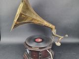 un vieux gramophone posé sur un support avec un socle en bois