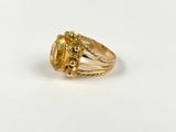 a close up of a gold ring with a citrine stone