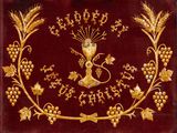 a close up of a gold plate with grapes and grapes on it