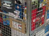 a metal cage filled with assorted items in a store