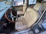 an old car with a leather seat and steering wheel