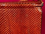 an image of a brown purse on a pink background
