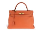 a brown leather handbag on a white background