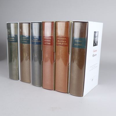 four books in a row on a white surface with a white background