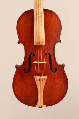 an old violin sitting on a white surface with a white background