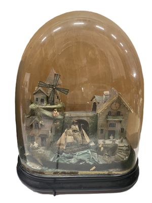 a snow globe with a house and windmill inside of it