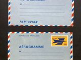 two airmail envelopes with airmail stamps on them sitting on a table