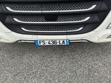 a close up of the front of a truck with a license plate on it
