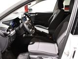 the interior of a white car with black seats and a steering wheel