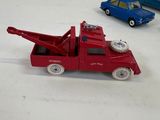 two toy cars sitting next to each other on a white surface