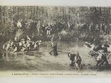 a black and white photo of a group of people in the water