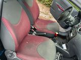 grey and red seat covers in the back of a small car