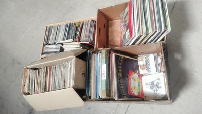 a lot of records in a box on the floor