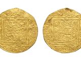 two gold coins, one of which has a picture of a man and a woman on it