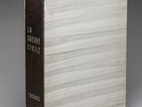 a book sitting on top of a white table next to a gray wall