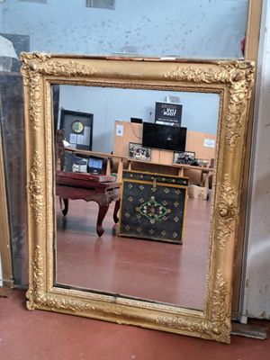a mirror that is sitting on the floor in a room