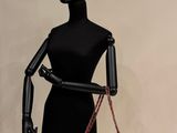 a mannequin with a red purse on display