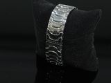 bracelet made of silver metal on a black surface