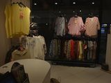 a picture of a clothing store with clothes on display