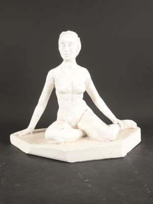 statue of a woman sitting in a lotus position on a marble base
