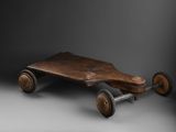 wooden skateboard with wheels on a grey background