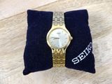 a watch that is sitting on a pillow on a table