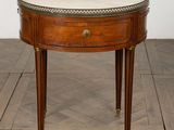 an image of a small table with a marble top on a wooden floor