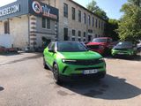 a green suv parked in front of a building