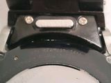 a close up of a toilet seat with a button on it