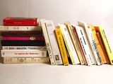 many books stacked on top of each other on a table