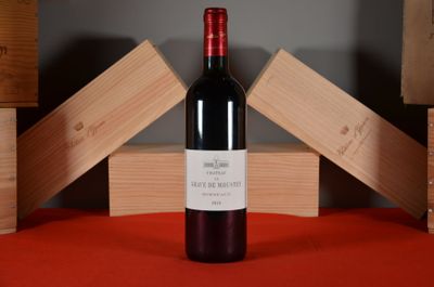 a bottle of wine sitting on a table next to wooden boxes