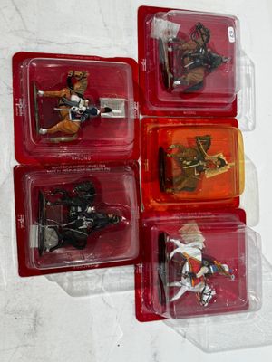 four different toy figures of a man riding a horse