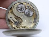 a close up of a pocket watch being held by a person