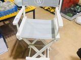 a white director ' s chair in the middle of a room