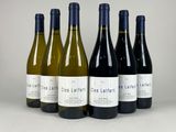 six bottles of wine are lined up in a row