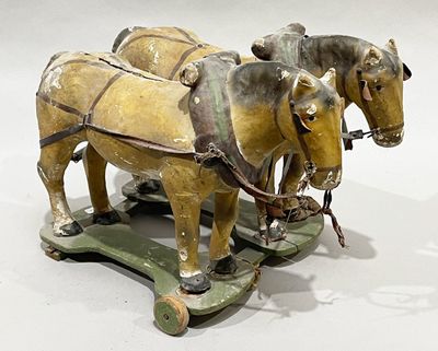 two horses pulling a cart with a man on it