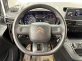 the interior of a car with a steering wheel and dashboard controls