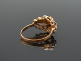 an image of a gold ring on a reflective surface