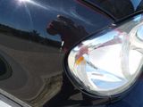a close up of a car ' s headlight with a dog on it