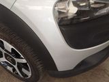 a close up of a white car with black rims