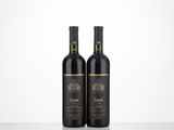 two bottles of wine sitting on top of a table next to each other