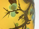 a yellow vase with a dragonfly design on it