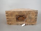 a wooden box with a metal handle and a tag on it