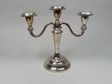 an image of a silver plated three - light candle holder on a white background