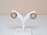 a pair of oplite and sapphire earrings on a white stand