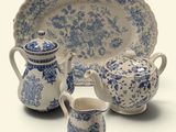 three pieces of blue and white china on display