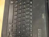 a black laptop computer sitting on top of a wooden table