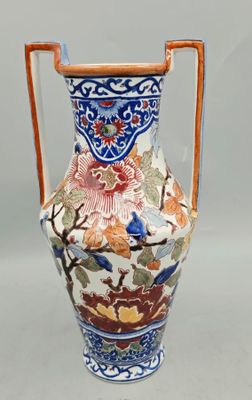 a vase with a handle that has flowers and birds on it
