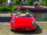 a red convertible car parked on the side of the road
