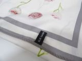 a close up of a pillow with a flower design on it
